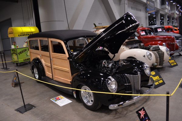 custom woody wagon hotrod on display at indoor car show