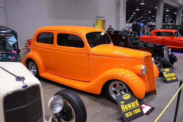 orange 1935 Ford Hot Rod on display at indoor car show