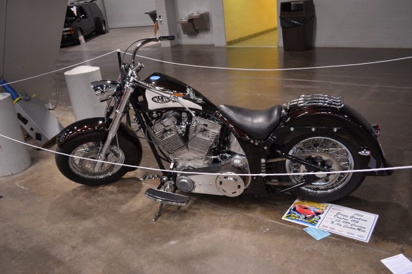 Custom American V-Twin Motorcycle at an Indoor Car Show