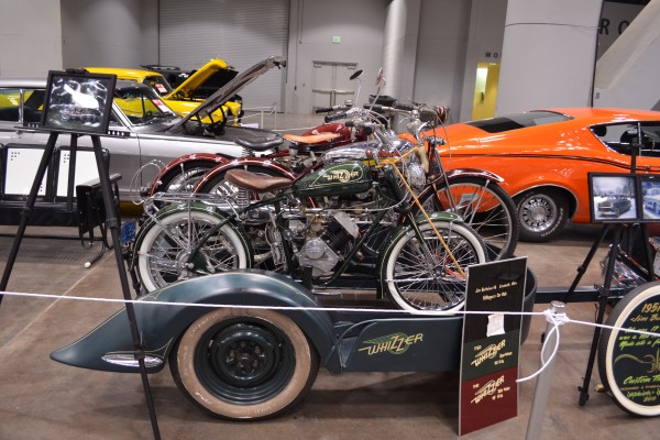 custom whizzer motorbikes at a car show
