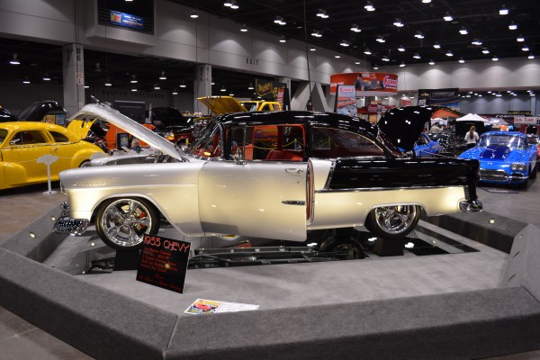 black and silver custom 1955 chevy displayed at indoor car show