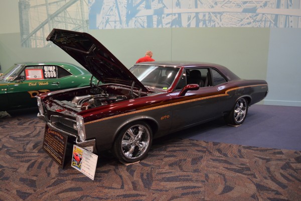 customized 1967 pontiac gto coupe displayed at indoor car show