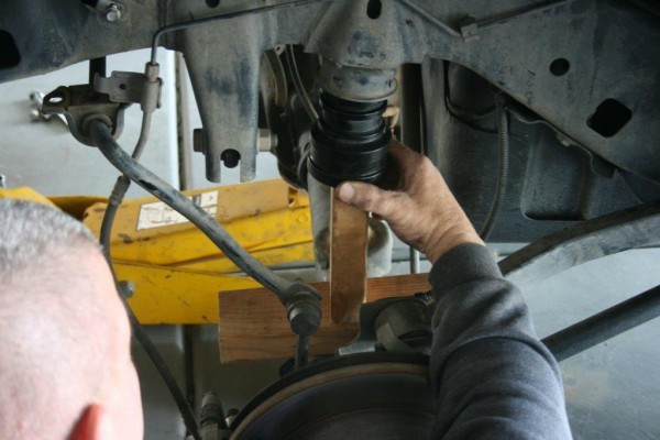 pressing bump stops into a jeep frame mount