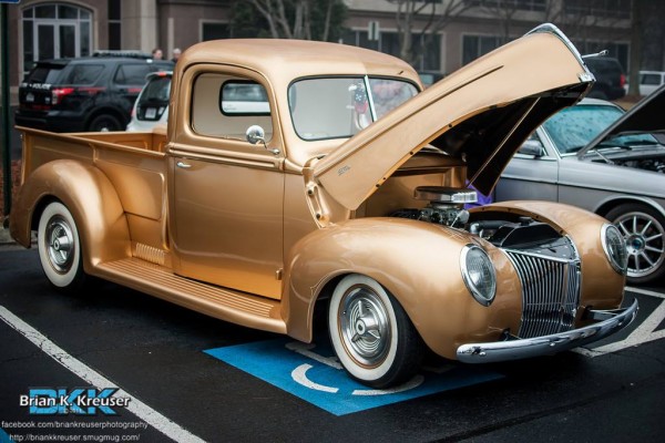 custom gold hot rod pickup truck at a local cruise in