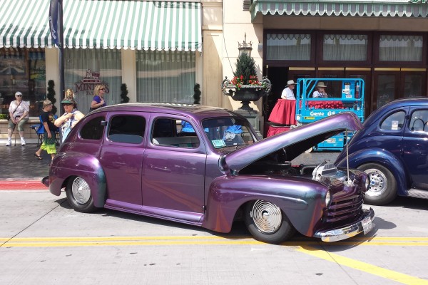 purple hot rod sedan parked on the street