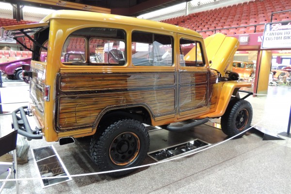 Vintage Willys wagon with custom woody paint and off--road wheels