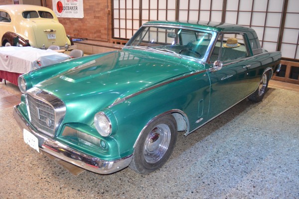 Vintage Green Studebaker Coupe displayed at indoor car show