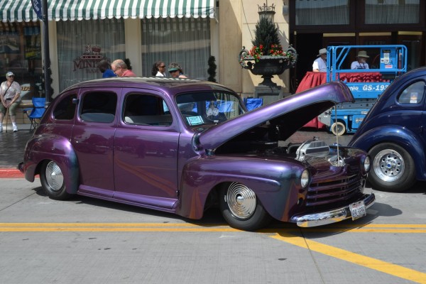 purple hot rod sedan parked on street