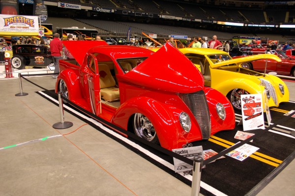 a pair of prewar hot rods with custom paint Displayed at Indoor Car Show
