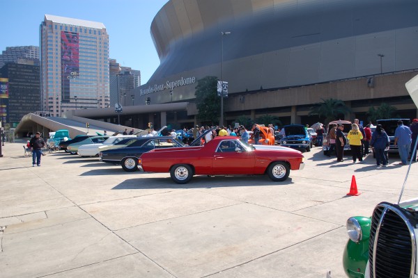 rows of classic cars outside of new orleans superdome