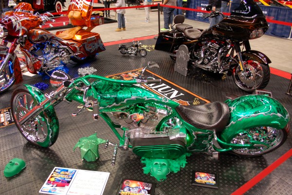 custom v-twin motorcycles displayed at a big indoor car show