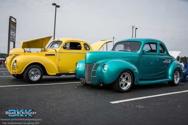 a pair of vintage ford hotrods at a local car show