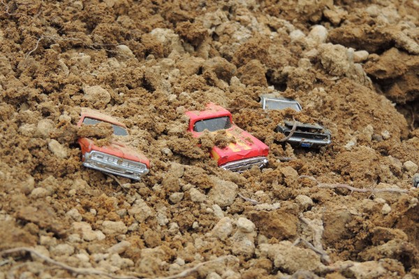 Toy cars covered in dirt