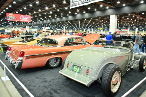 row of classic cars on display at indoor car show