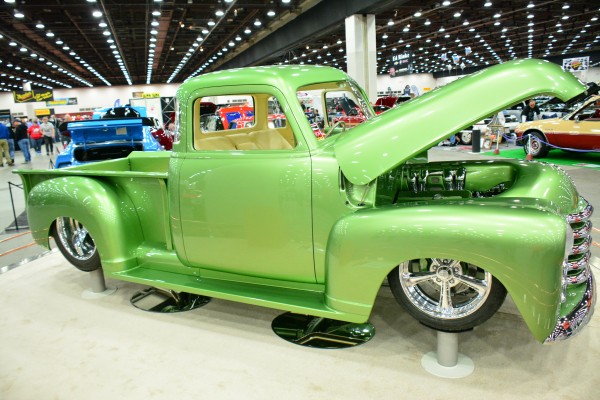 custom green chevy pickup truck 3100 on display at indoor car show