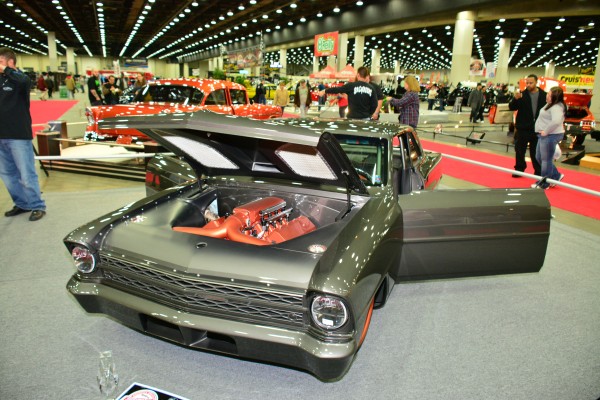 customized chevy 2 nova on display at indoor car show