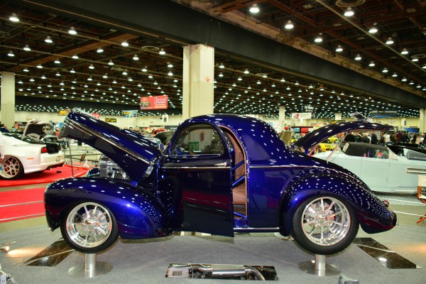 blue ford prewar coupe on display at indoor car show