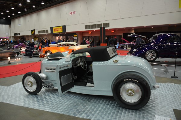 ford roadster coupe on display at indoor car show