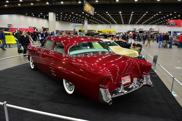 red custom postwar coupe on display at indoor car show
