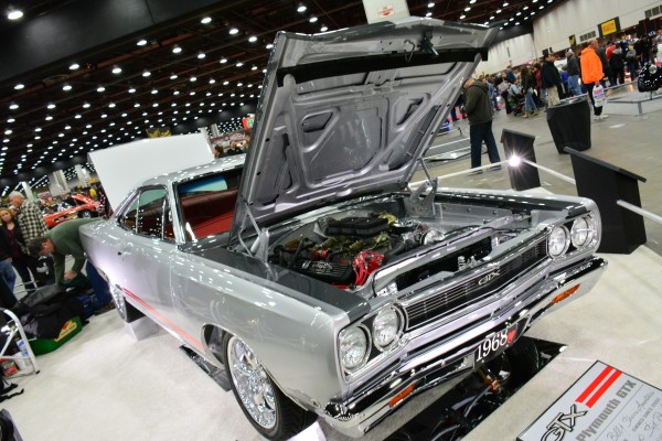 silver 1968 plymouth gtx on display at indoor car show