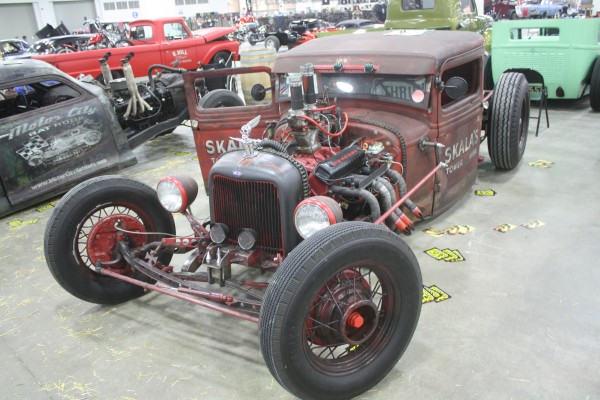 vintage ford truck rat rod on display at indoor car show