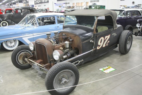 vintage style ford roadster hot rod on display at indoor car show