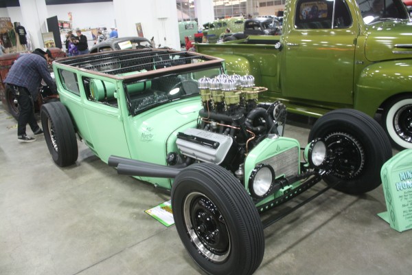 vintage custom green ford hot rod on display at indoor car show
