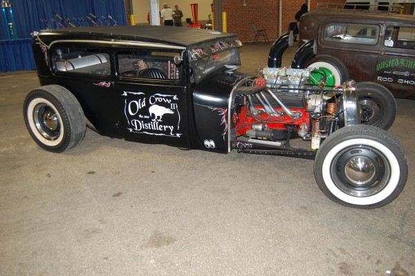old crow distillery rat rod ford coupe on display at indoor car show