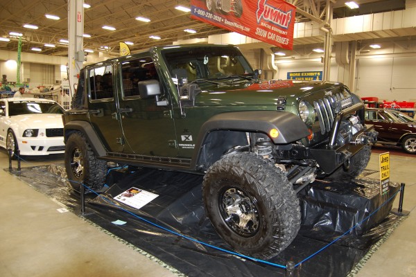 customized jeep wrangler jk on display at indoor car show