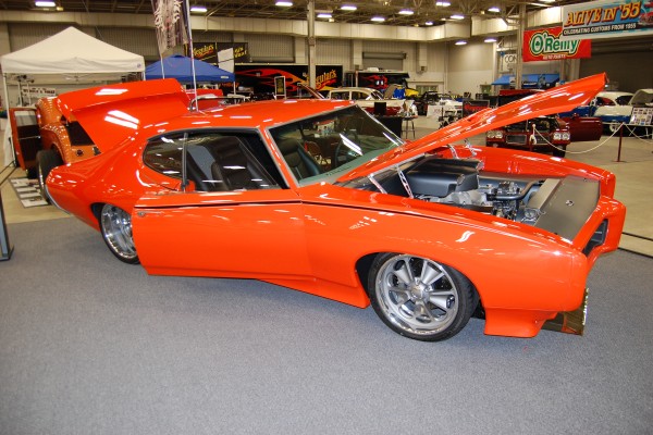 custom gto judge coupe on display at indoor car show