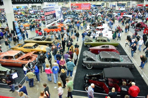 crowds at a large summit racing indoor car show