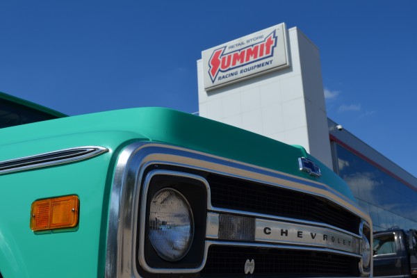 summit racing sign behind 1969 chevy c10 pickup truck grille