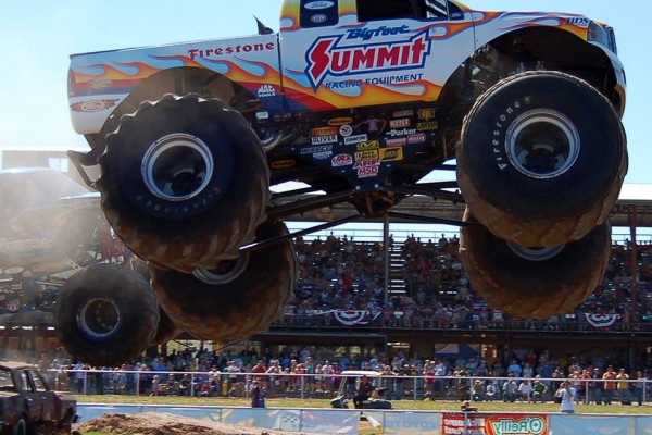 bigfoot monster truck leaping over cars during race