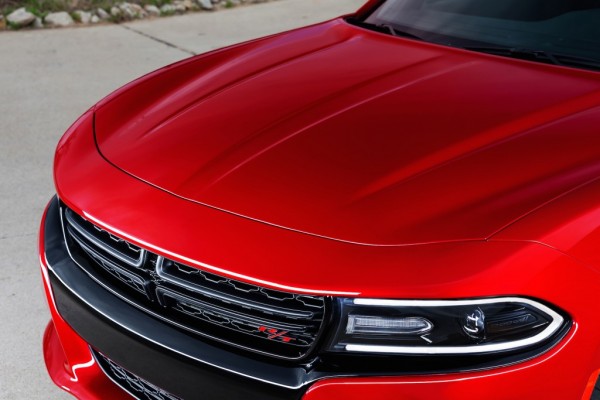 front headlight and grille of a red 2015 dodge charger sedan