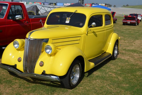 yellow hot rod coupe at a car show