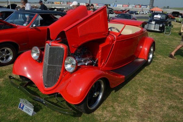 vintage red hot rod roadster with chopped and raked windshield
