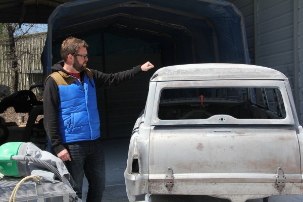 rutledge wood knocking on bare steel roof of a plymouth suburban body