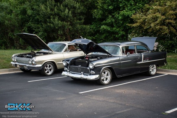 a pair of vintage chevy cars at a local cruise in show