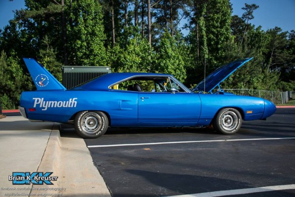 side profile shot of a parked blue 1970 plymouth roadrunner superbird