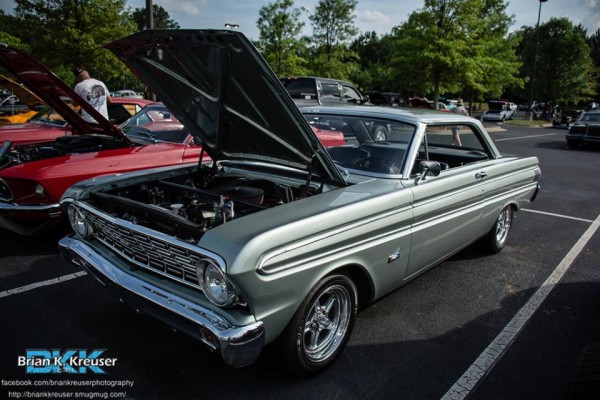vintage ford falcon coupe at a car show