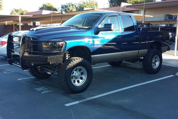 a lifted dodge truck with an off road push bumper