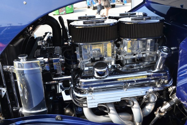 v8 engine with customized quad carburetor setup in an old hot rod