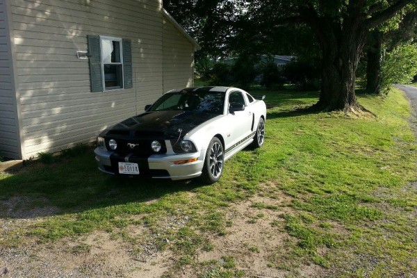 an s197 ford mustang parked near a house