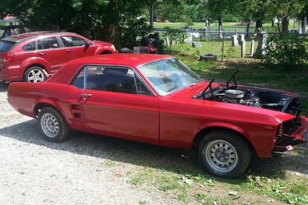 1967 ford mustang project car in driveway