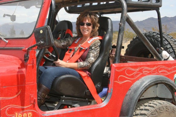 woman in the driver seat of a off road jeep cj-7
