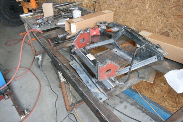 custom racing seat brackets on a welding table