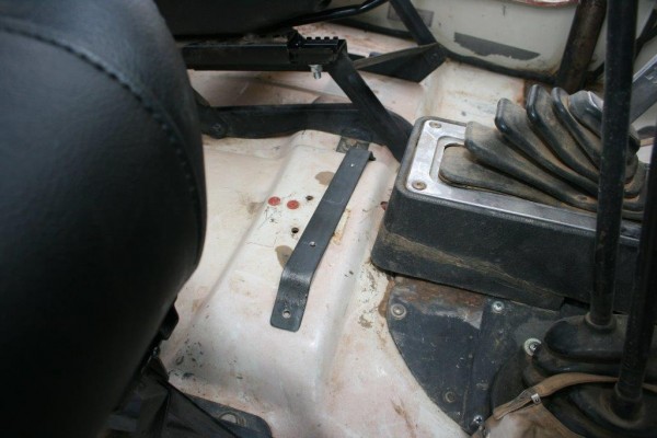 seat console bracket on the floor of a jeep cj