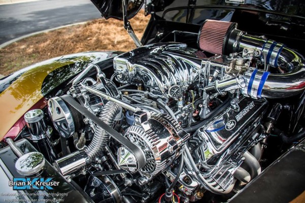 ford v8 engine with chrome accessories in a hot rod engine bay