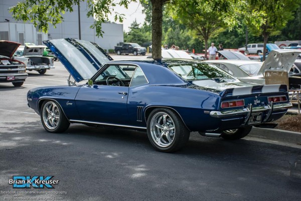 rear view of a blue 1969 chevy camaro z/28 with custom wheels