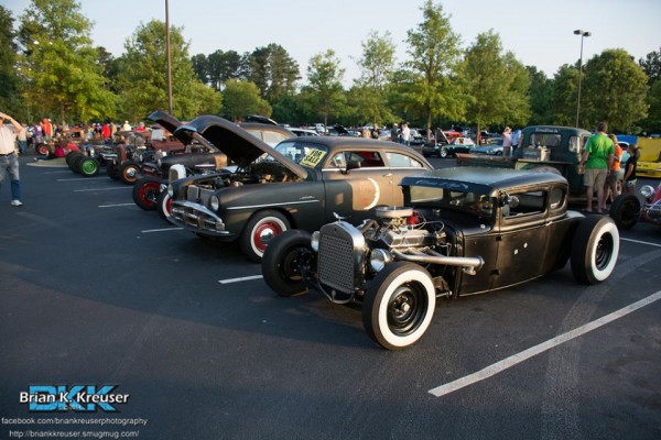 rows of hot rods and classic cars at a summit racing cruise in